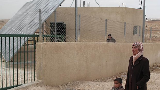 Mihad Moor, 25, and her son Mohammed at the solar panel station set to be demolished by the Israeli government.