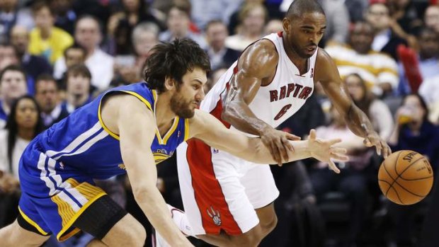Golden State Warriors' Andrew Bogut (left) battles for the ball with Toronto Raptors' Alan Anderson.