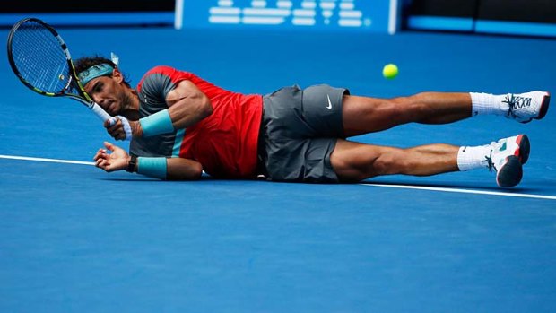Rafael Nadal takes a tumble during his fourth-round match against Kei Nishikori on Monday.