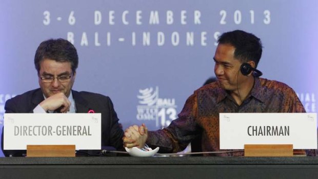 World Trade Organisation director-general Roberto Azevedo (left) is congratulated by conference chairman Gita Wirjawan of Indonesia.