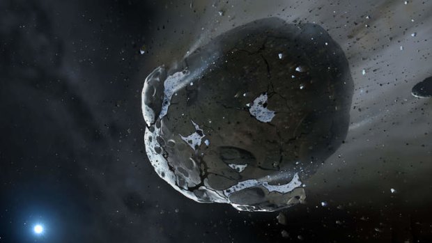 An artist impression of a water-rich asteroid being torn apart by the strong gravity of the white dwarf star GD 61. Scientists say they have found evidence of an apocalypse in another planetary system.