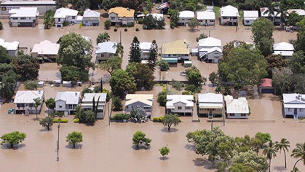 The Rockhampton floods, pictured yesterday, are yet to peak.