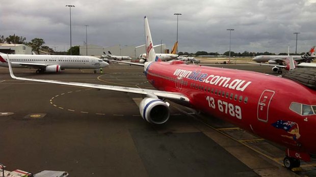 Parking problems: planes line up at Sydney Airport.
