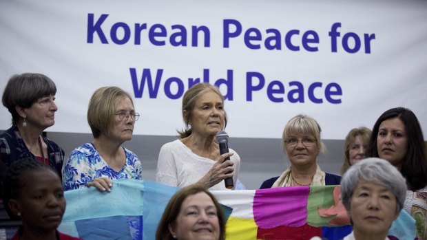US activist Gloria Steinem (rear centre)  speaks among the members of the Women Cross DMZ group during a news conference before they leave for Pyongyang, at a hotel in Beijing, China.