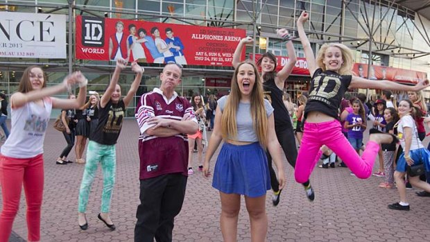 For the young and young at heart: Alan Stokes (centre) with his teenage daughter Claire at the One Direction Concert in Sydney.