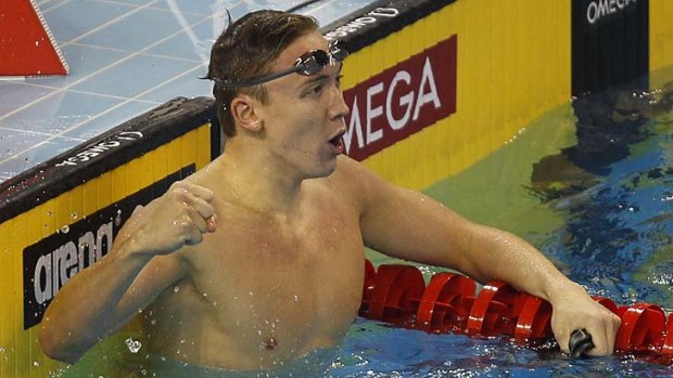 Robert Hurley gestures after winning the men's 100 metres backstroke final.