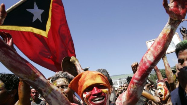 East Timorese demonstrators painted the colour of the Timorese flag celebrate after Prime Minister Mari Alkatiri's announcement that he will resign Monday June 26, 2006 in Dili.