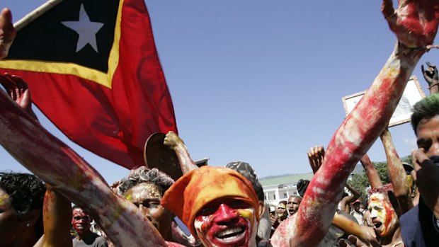 East Timorese demonstrators painted the colour of the Timorese flag celebrate after Prime Minister Mari Alkatiri's announcement that he will resign Monday June 26, 2006 in Dili.