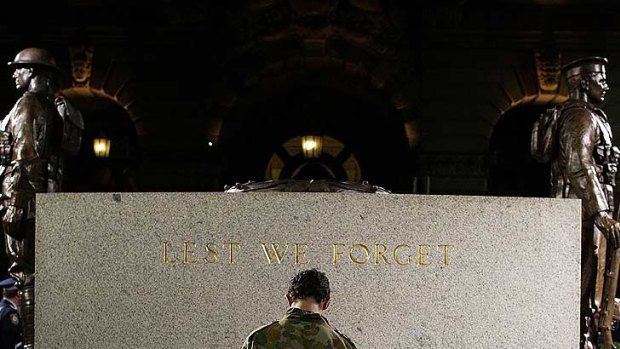 A serviceman pays tribute in front of the ANZAC Cenotaph at Martin Place in Sydney this morning.