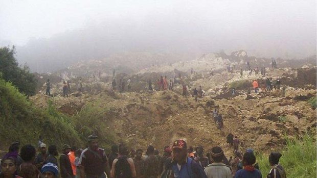 Destruction ... villagers search the site of the disaster which is reported to have killed at least 40 people.