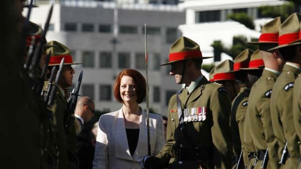 Moment in the sun ... Julia Gillard inspects a guard of honour outside the New Zealand Parliament in Wellington yesterday.