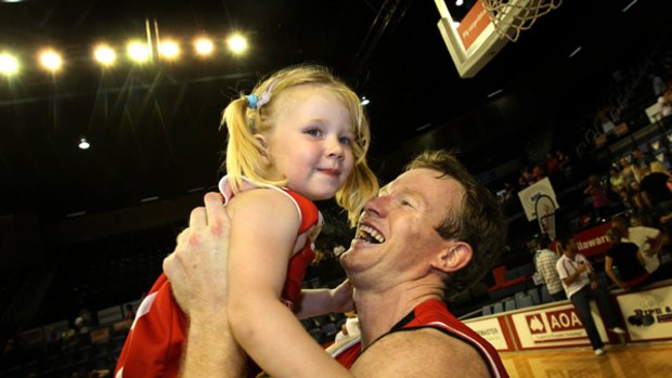 The saviour ... Wollongong Hawks captain Mat Campbell celebrates with daughter Hannah.