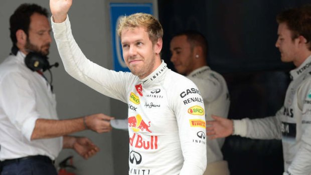 Sebastian Vettel of Germany waves to the crowd after qualifying first.