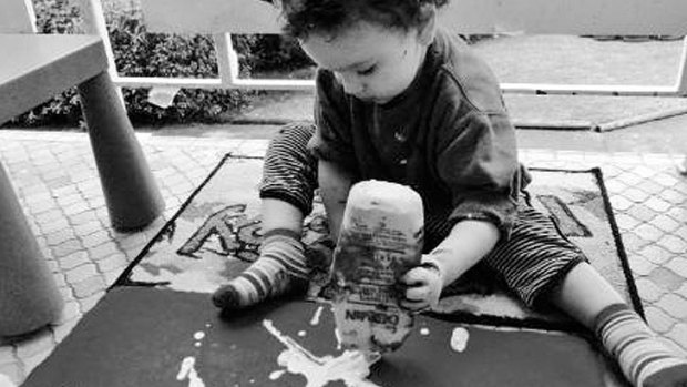 Vinnie Macris works on another painting.