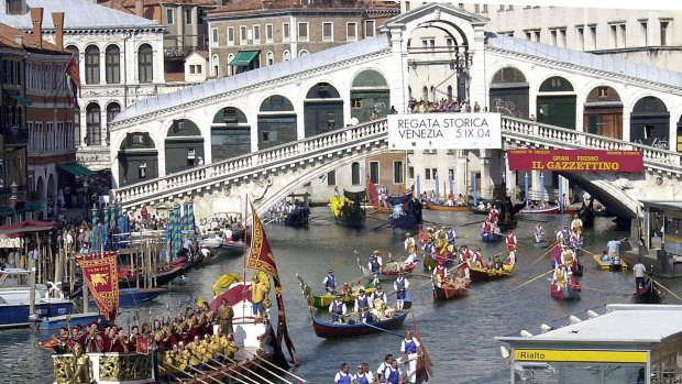 The Rialto bridge along the Grand Canal, during the annual historical regatta, in Venice, Italy.
