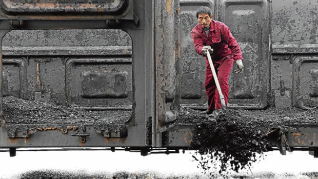 A miner unloads coal at a coal storage site in Hefei, Anhui province, China.