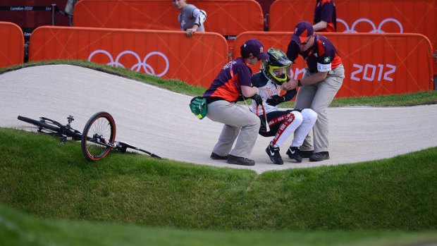 US rider Brooke Crain is assisted after a crash.
