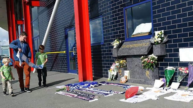 Prayers ... Fans and well-wishers leave messages and flowers outside Reebok Stadium in Bolton.