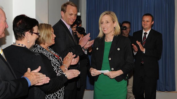 Gallagher  is applauded by Simon Corbell, Andrew Barr and other Labor MLAs after her press conference.