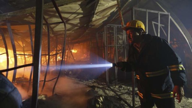 A firefighter inspects a fire inside a garment factory in the Bangladeshi town of Gazipur. Nine employees died in the blaze.