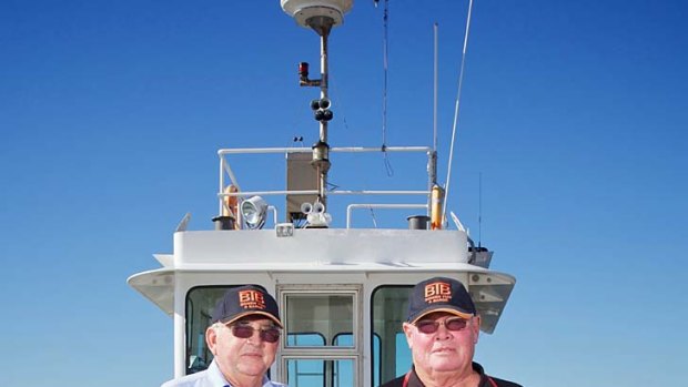 Tugboat skippers Peter Fenton (right) and Doug Hislop risked their lives to prevent a potential catastrophe on the raging Brisbane River during the flood crisis.