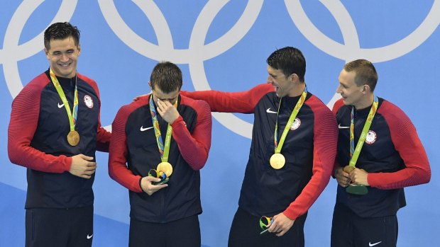 The US team receives its gold medals.