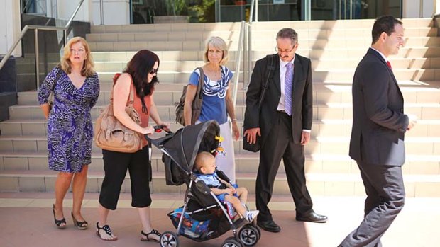 Jenny Diefenbach (second from left) leaves the Rockhampton courthouse with (from left) her mother Margaret Kimmorley, her son Noah, her parents-in-law Lyn and Ken Diefenbach, and Maurice Blackburn Lawyers principal Gino Andrieri.