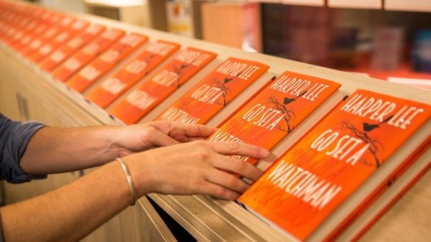 A customer picks up a copy of Harper Lee's <i>Go Set A Watchman</i>