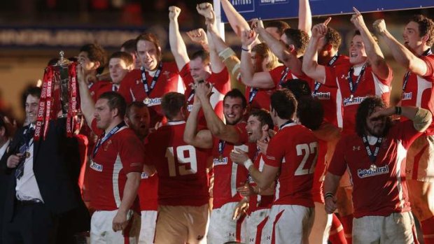 Bad memories: Wales lift the Six Nations trophy after dismantling England last year.