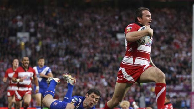 Runaway win . . . Wigan's Martin Gleeson evades the desperate tackle of Paul Wellens of St Helens on the way to one of his two tries.