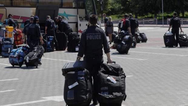 Members of the Australian police mission arrive at Kharkiv airport en route to the crash site.