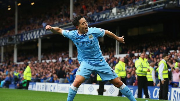 Late strike: Samir Nasri celebrates City's second goal against Everton.
