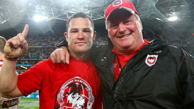 Dean Young with his father Craig after last year's Grand Final win. Young is in the squad but will not play against Wigan this month due to injury.