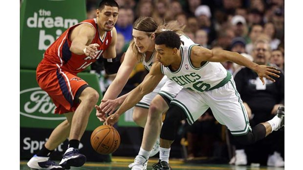 Atlanta Hawks forward Gustavo Ayon (left) and Boston Celtics centre Kelly Olynyk (centre) and guard Phil Pressey chase a loose ball in the second quarter.