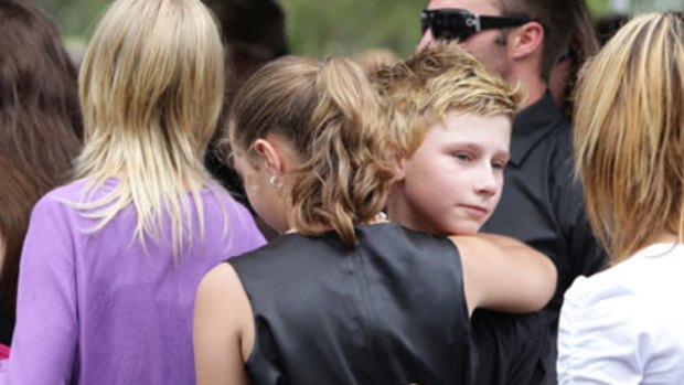 Comfort ... Blake Rice, 10, at yesterday's funeral.