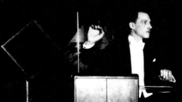 Leon Theremin with a theremin, an early electronic musical instrument.