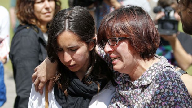 Relatives of the victims of a train accident react outside the Cersia building, where they are attended by psychologists from the Red Cross in Santiago de Compostela.