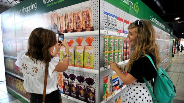 Food for thought ... Alana Pozzebon (left) and Liv Cougan check out the Woolworths virtual supermarket.