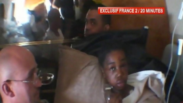 Baya Bakari receives medical attention during her journey by French government jet.