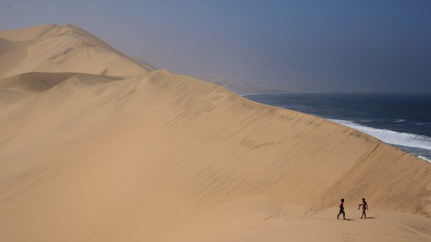 I had the chance to visit Namibia from South Africa. A four wheel drive, up, over and down immense sand dunes was both scary and exciting.

This picture of two people in the dunes helps one realise both how big the dunes are, as well as their proximity of the Atlantic Ocean.