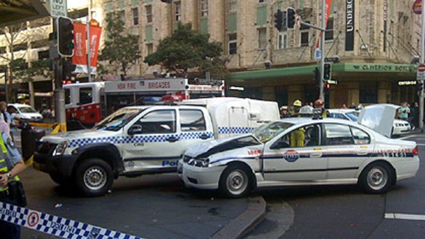 Crunch ... the police car and taxi after the accident in Pitt Street.