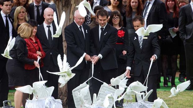 The way they remember her best: Doves and tears released at murder victim Jill Meagher's funeral at Fawkner Cemetery yesterday.