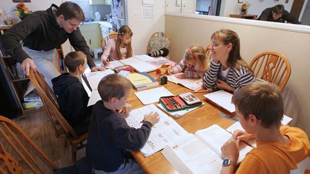 Uwe Romeike, top left, and his wife Hannelore, second from right, teaching their children at their home in Morristown, Tenn.
