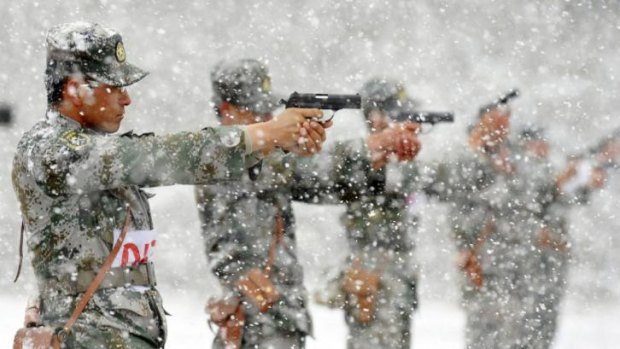 Too corrupt to fight successfully? Chinese People's Liberation Army soldiers practice shooting with pistols at a military base amid heavy snowfalls.