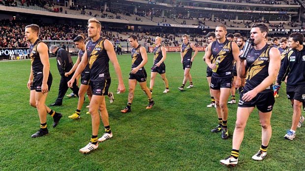 Richmond walk off after losing to Essendon at the MCG.