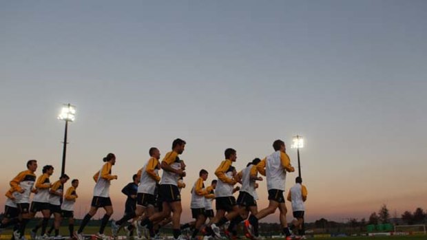 Twilight zone ... the Australian squad enjoys a leisurely hit-out at Roodeport Stadium a week out from the opening match against Germany.