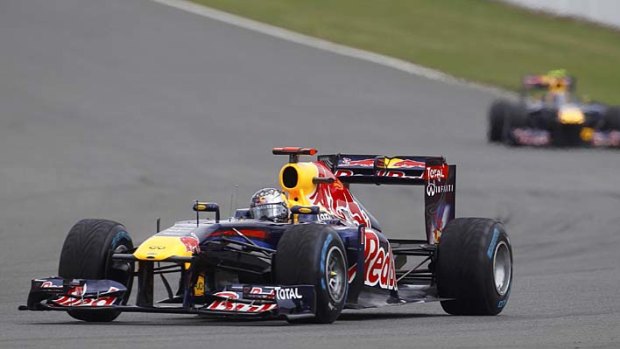 Sebastian Vettel drives ahead of Red Bull teammate Mark Webber at Silverstone. Webber finished third, with Fernando Alonso taking out the race.