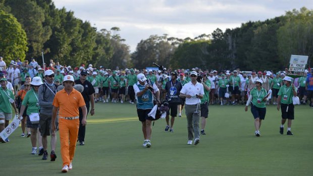 Perfect storm: Adam Scott (centre) on the last hole on his way to winning the Australian PGA.