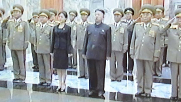 This screen grab shows North Korean leader Kim Jong-un, centre, with a mystery woman paying tribute to his late grandfather Kim Il-sung.