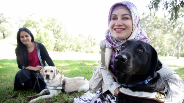 Karima Shirzad with her guide dog Tashi (left) and Neslihan Sari with Sarita.  The women had to overcome cultural resistance to the idea of owning dogs.